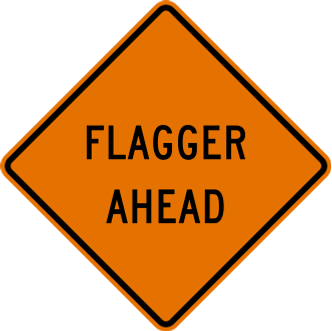 Flagger Ahead sign: orange diamond with the words FLAGGER AHEAD.