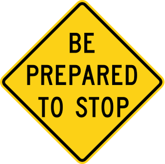 Yellow diamond-shaped sign with black lettering.