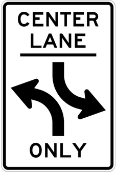 Two-Way Left Turn sign: white rectangle reading CENTER LANE ONLY with two opposite left-turn arrows.